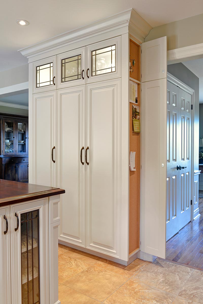 Concealed message center and key storage with cork board open
